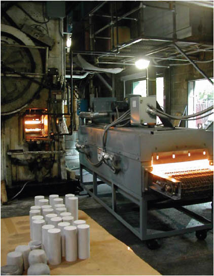 FIGURE 4.8 Continuous-belt infrared furnace for high-performance aluminum forgings. Testing of this system at Queen City Forging Company confirmed that it is more than three times more energy-efficient than current convection furnaces in preheating aluminum billets. It also provides grain refinement that enhances fatigue properties. Infrared preheated and forged components have been shown to last two times longer than conventionally preheated forgings.
