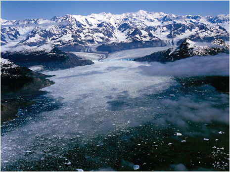 FIGURE 1.5 Global warming, retreating glaciers, and changing landscapes. The Columbia Glacier, flowing into Prince William Sound, Alaska, presently is undergoing rapid retreat that is likely to last another few decades. The glacier produces prodigious quantities of icebergs, which debouch into the sound near the shipping lane from the Valdez terminus of the Alyeska pipeline. The retreat is accompanied by thinning of the ice, revealing up to 400 meters of freshly exposed bedrock that bounds the present glacier. SOURCE: Photo courtesy of Robert S. Anderson.